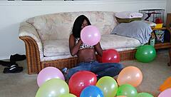 Bold French Ebony Woman Inflates Balloons with Intense Energy and Flair