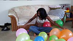 Bold French Ebony Woman Inflates Balloons with Intense Energy and Flair