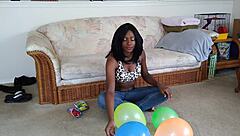 Bold French Ebony Woman Inflates Balloons with Intense Energy and Flair