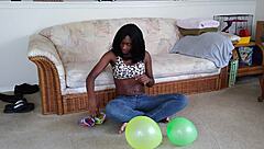 Bold French Ebony Woman Inflates Balloons with Intense Energy and Flair