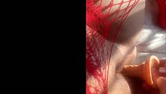 Hey, watch this curvy Latina in red body shoving dildo deep moaning wildly  