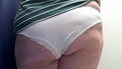 I spy on a chubby milf with big ass in white panties trying tight leggings in the fitting room, camera capturing every close-up detail of her curvy blonde body