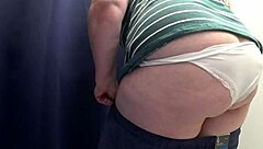I spy on a chubby milf with big ass in white panties trying tight leggings in the fitting room, camera capturing every close-up detail of her curvy blonde body