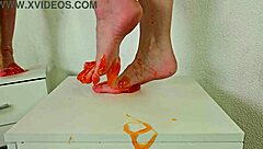 alice klay plays feet with orange slime closeup