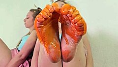 alice klay plays feet with orange slime closeup