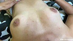 Brunette in fishnets plays with outfit close-up