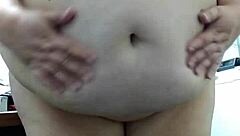 Boldly undressing in the office, the fat nude woman exposes herself publicly outdoors at work.