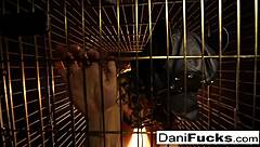 Dani Daniels, the brunette pornstar, masturbates as a bitch inside a cage, teasing her big tits and pussy.