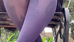 in the spring outdoor air, a woman teases with her mini skirt and nylon pantyhose, showing off her feet while walking