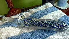 Alexis Grace strips naked in green lingerie, flaunting her shaved body and piercings while masturbating solo