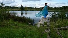mature lady in bikini dancing on the lake
