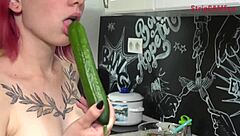 Olivia teases with cucumber in kitchen, performs blowjob on webcam, shows tattoo