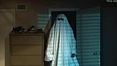 A nude blonde girl celebrates Halloween in bed.