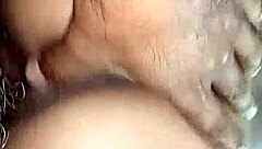 the young woman savors a delicious blowjob in the bedroom, her lips wrapped tightly around the throbbing cock as she takes it deep, moaning softly with each thrust from behind.