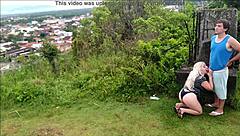 Horny blonde slut sucks African guy's cock on the beach