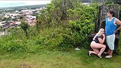 Horny blonde slut sucks African guy's cock on the beach