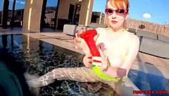 Red XXX teases pussy with toy by pool
