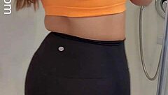 Hey, check out this hot babe in sports bra and leggings getting off in the shower! 😏