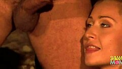 lubing up his cock to slip into the blonde's anal outdoors