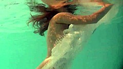 Russian babe Natalia swims nude and strips