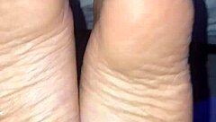 A man cums all over a woman's feet during a footjob