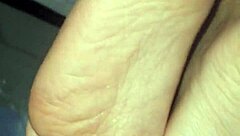 A man cums all over a woman's feet during a footjob