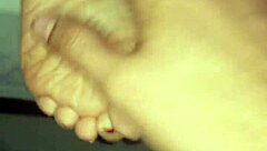 A man cums all over a woman's feet during a footjob