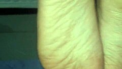 A man cums all over a woman's feet during a footjob