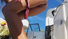 Brunette shows pussy and pees from speed boat in marina.