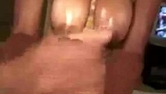 Ebony milf with big oiled boobs strokes cock in pov