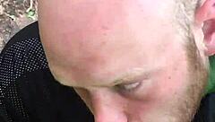 Hunk gives deepthroat blowjob to monster cock in outdoor nature setting