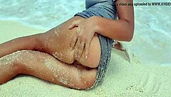 Sexy blonde rubs herself by sea with sandy hot ass