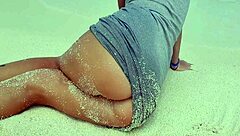 Sexy blonde rubs herself by sea with sandy hot ass