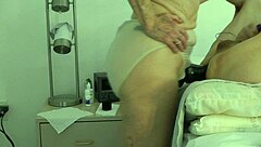 wife takes control, pegging her submissive husband in a domination session at home