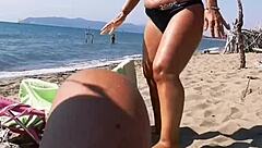 Watch this wife give blowjobs and handjobs on the beach? Her big ass and pussy are on display!