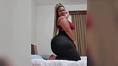 She shows her big ass in tight black leggings.