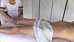 Asian Masseuse in Uniform Gives Oiled Massage Leading to Orgasm and Cumshot.