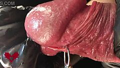 close-up extreme view of latex gloves detailing peehole and cumshot