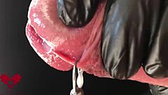 close-up extreme view of latex gloves detailing peehole and cumshot
