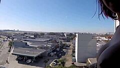 naked at hotel window in front of airport with big tits