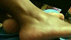 wife gives footjob to husband at home