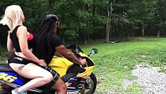 Nadia White drilled on motorcycle outside.