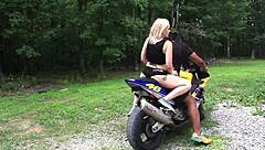 Nadia White drilled on motorcycle outside.