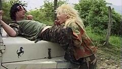 La Soldatessa Seduces Soldier and Landowner in Steamy Outdoor Encounter with Vintage Charm.