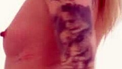 blonde relaxes in fishnets and stockings