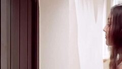 Two women kiss and love each other in a mature lesbian setting.