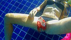 Girl fucks black dildo in public pool