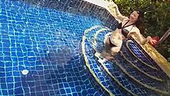 Girl fucks black dildo in public pool