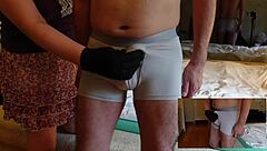 Femdom teases cock with handjob and slaps over pants.