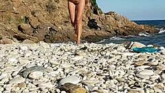 Naked Latina inserts pebbles on public beach solo walk